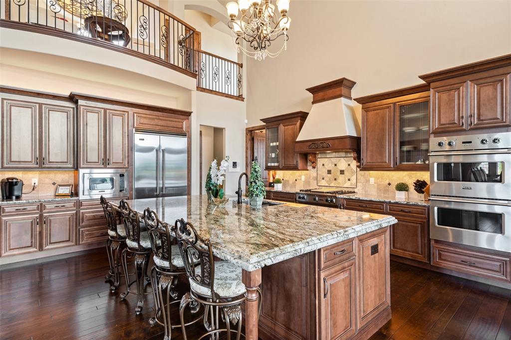 Image 8 of 50: Gourmet kitchen with a spacious granite island with top of the line Viking 