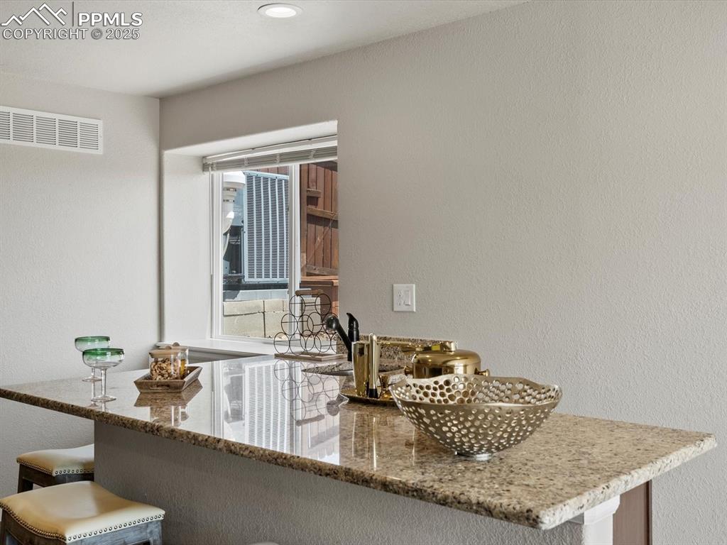 Image 36 of 50: Wet Bar with sink and mini fridge
