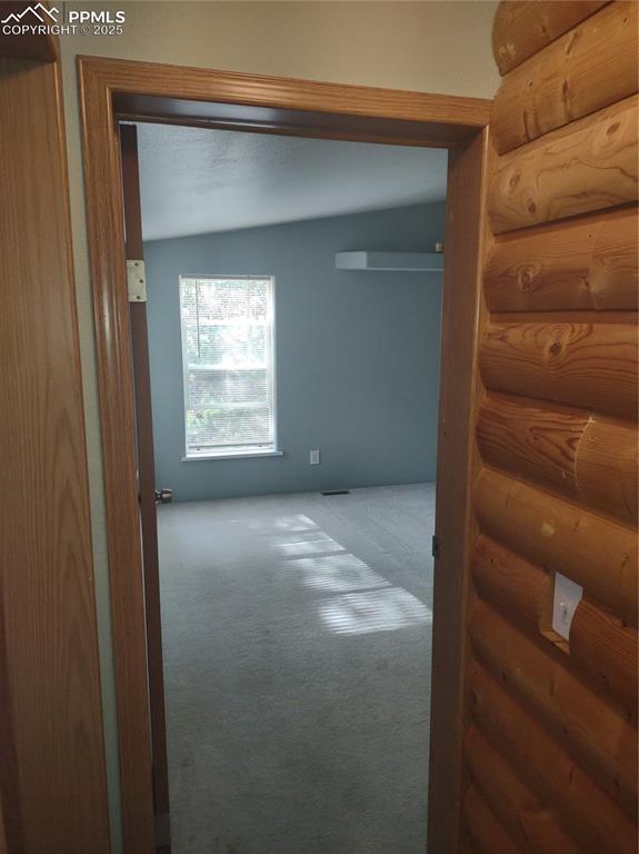 Image 23 of 44: Hallway connecting three bedrooms and full bath.