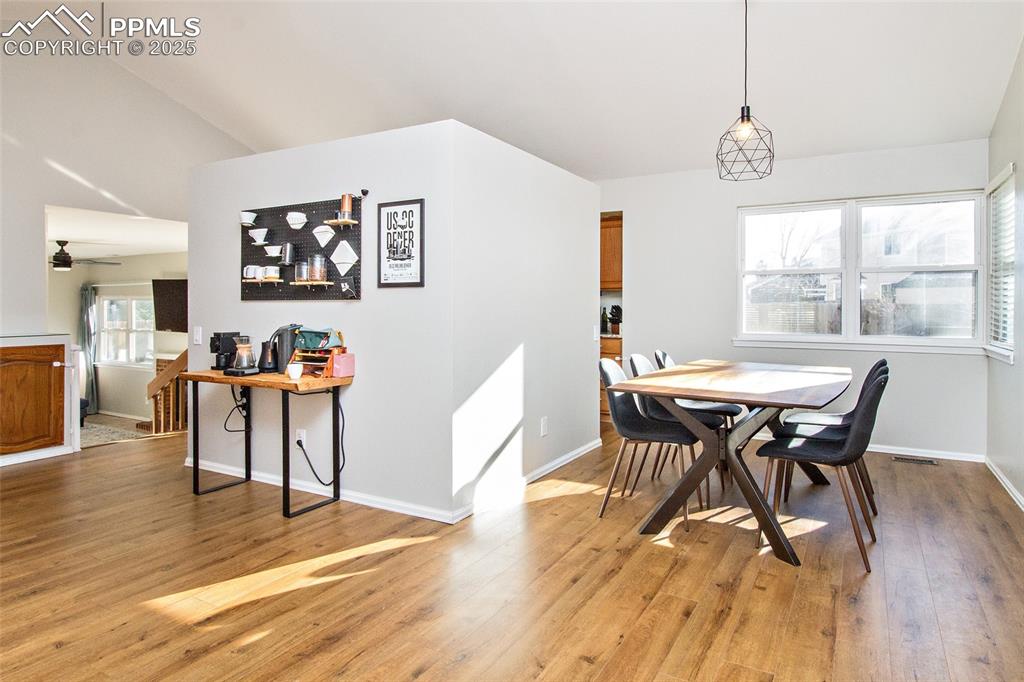 Image 15 of 43: Dining room with lofted ceiling, light wood finished floors, and a ceiling 