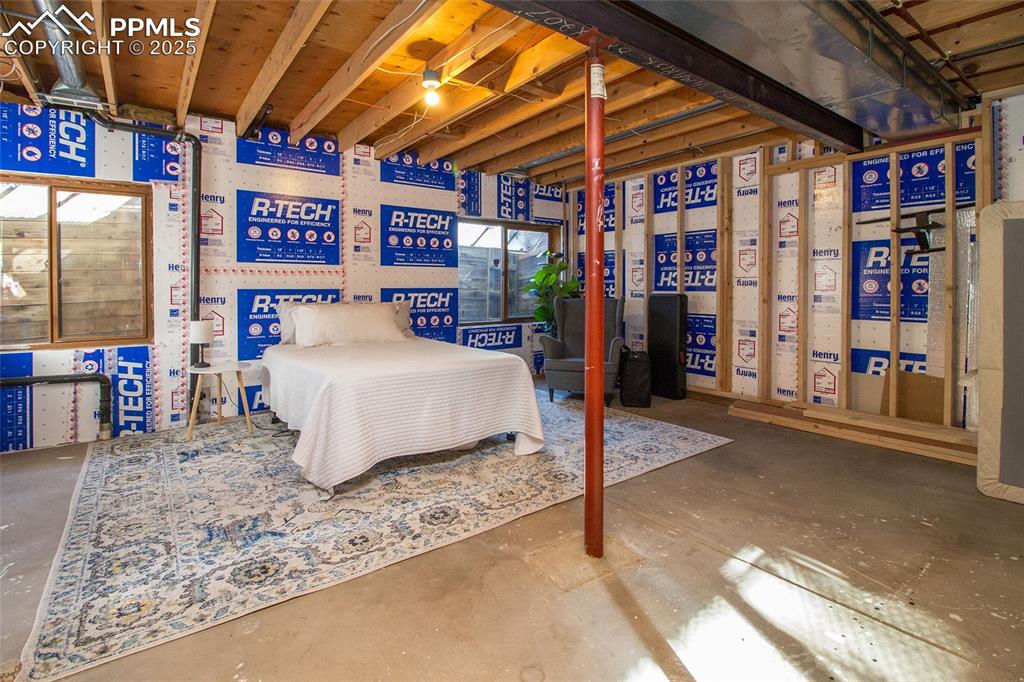 Image 31 of 43: Bedroom with concrete floors