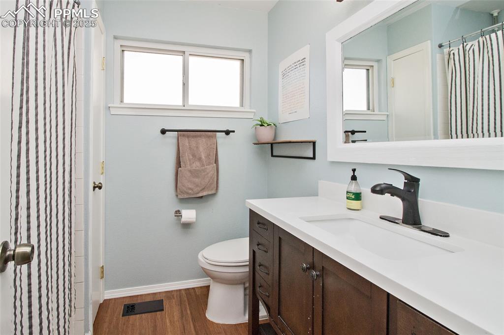 Image 38 of 43: Full bathroom featuring a shower with shower curtain, vanity, dark wood-typ