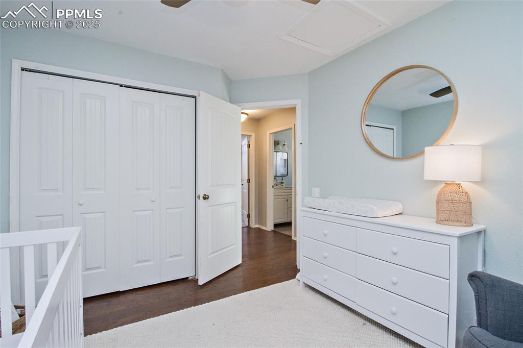 Image 40 of 43: Bedroom with a closet, dark wood-style flooring, and ceiling fan