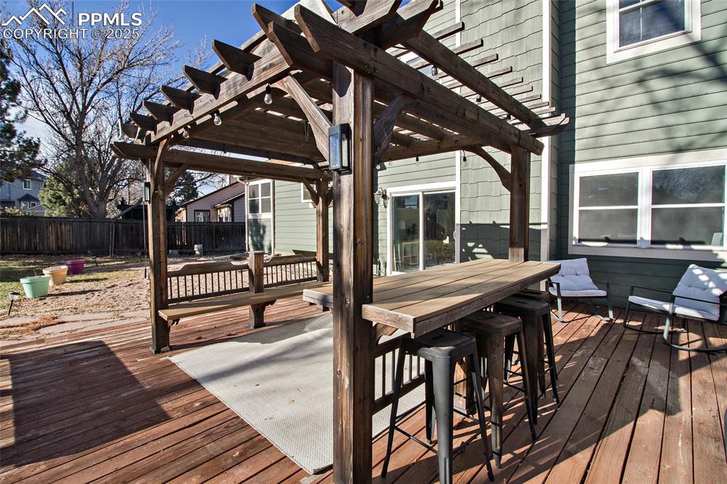 Image 8 of 43: Wooden deck with outdoor dining space