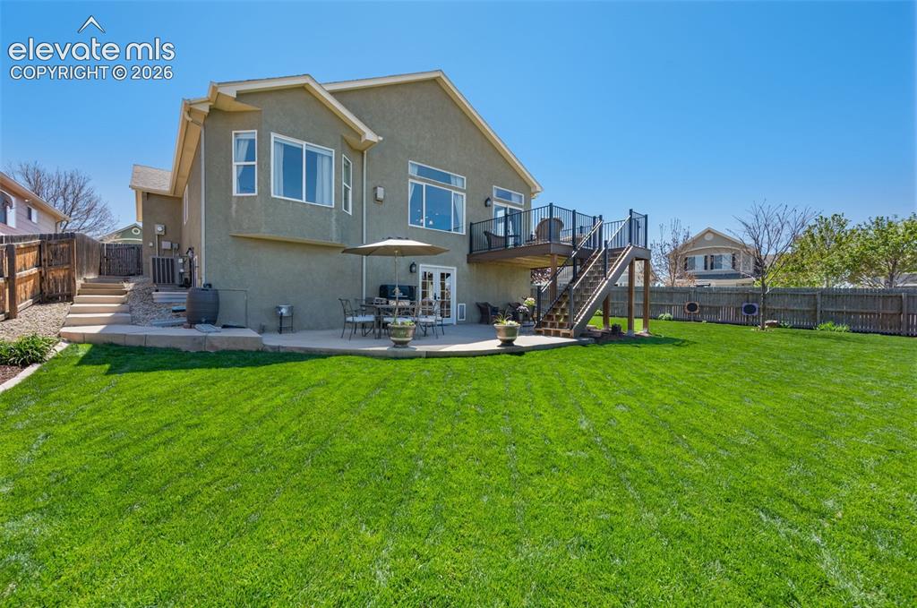 Image 47 of 50: Extensive concrete patio including a walkway up to the front