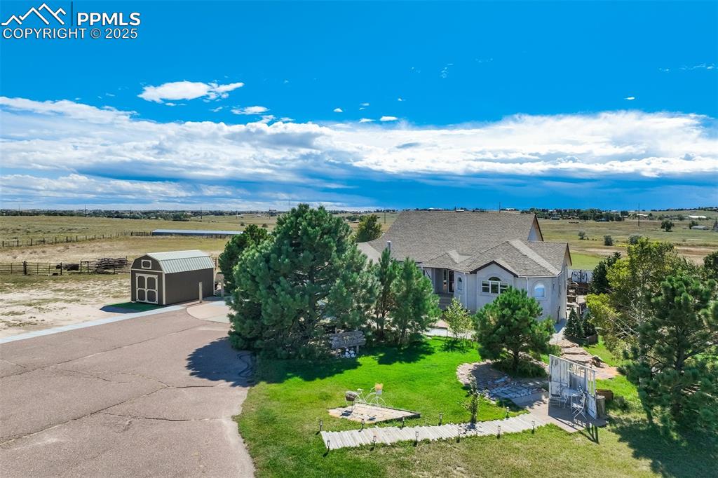 Image 3 of 50: View of front of home with a rural view and a storage unit