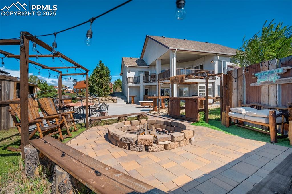 Image 40 of 50: Patio / terrace featuring a patio area, an outdoor fire pit, and stairway