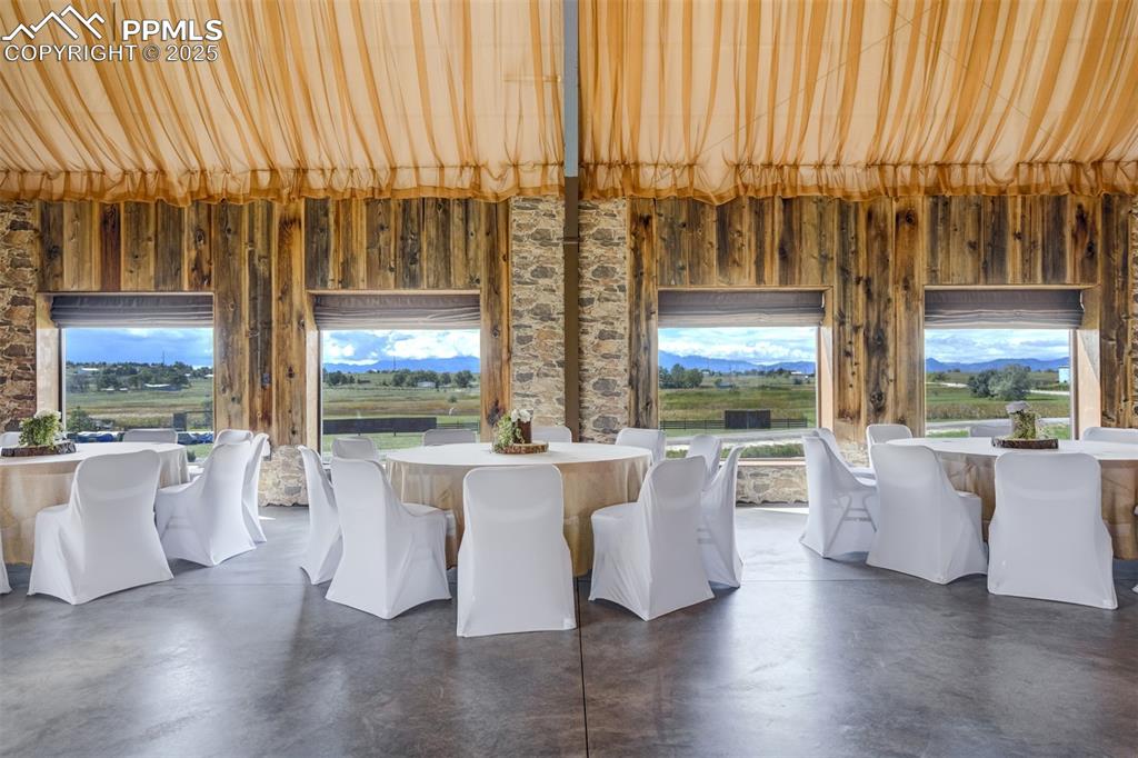 Image 48 of 50: Dining space featuring finished concrete flooring and plenty of natural lig