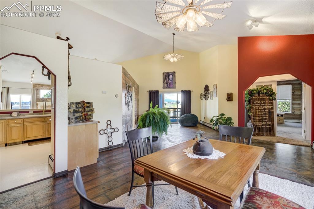 Image 8 of 50: Dining space featuring healthy amount of natural light, dark wood finished 