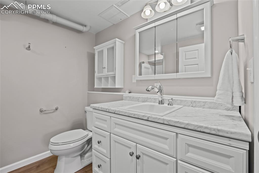 Image 27 of 42: Bathroom with vanity and dark wood-type flooring