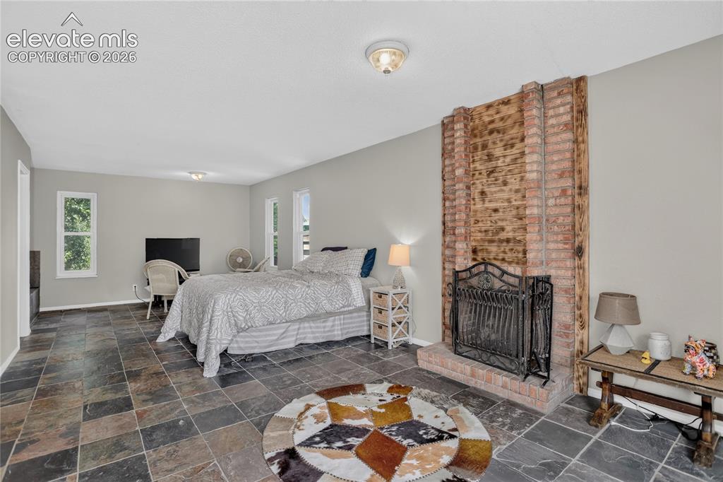 Image 12 of 23: Large primary suite w/ fireplace
