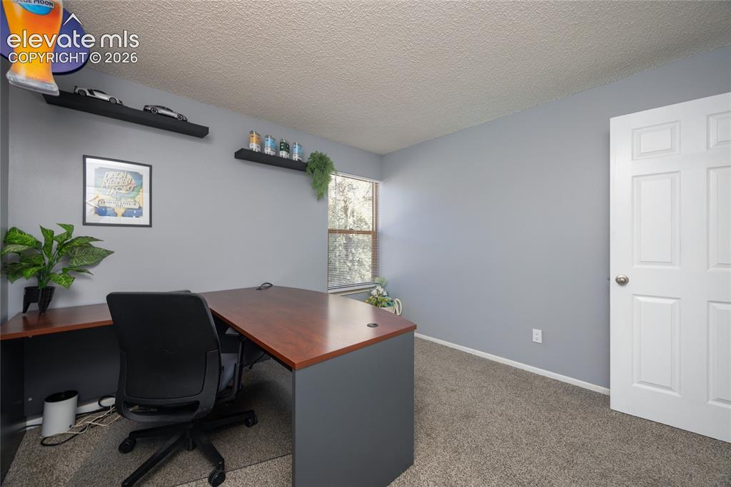 Image 14 of 25: 2nd Bedroom is being used as an office.