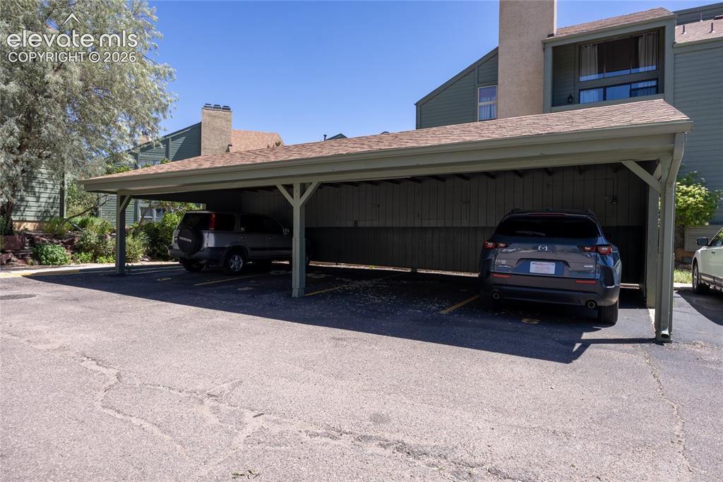 Image 24 of 25: Assigned carport and storage area.