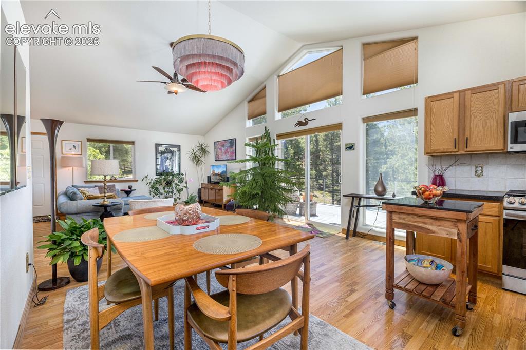 Image 11 of 36: Dining area and kitchen feature a walkout to the deck.