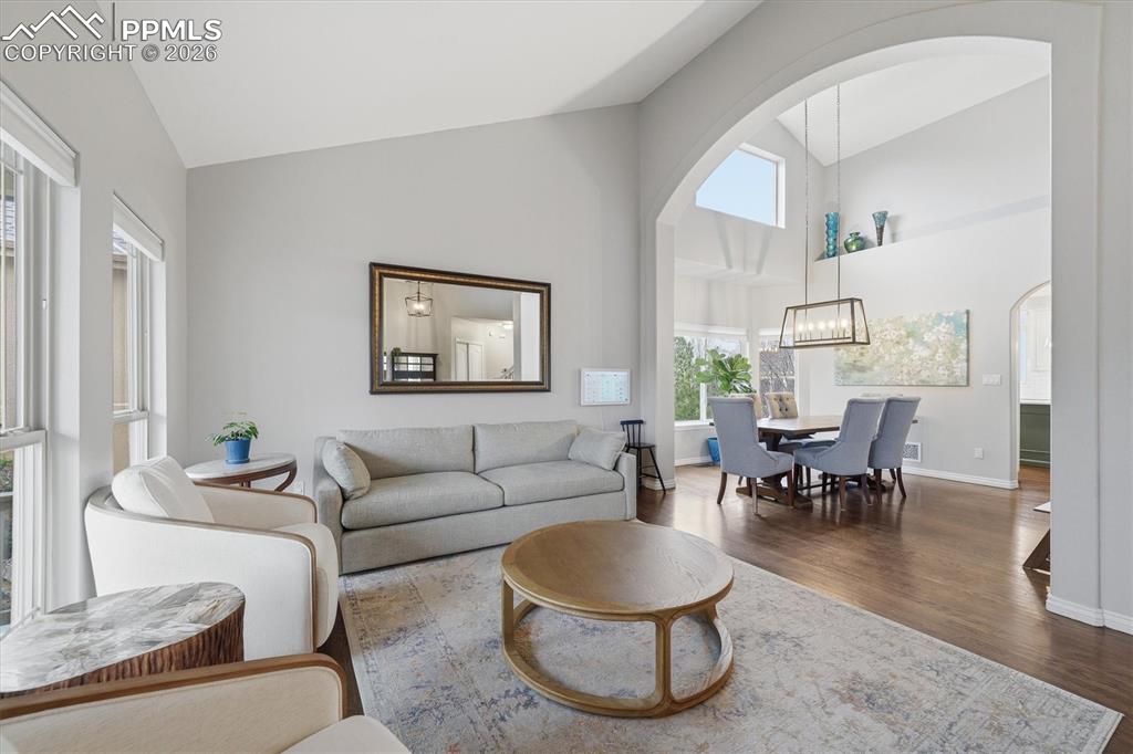 Image 6 of 50: Formal living room + vaulted ceilings