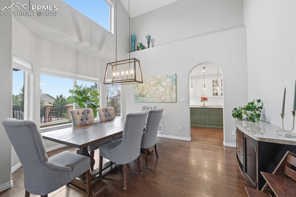 Image 9 of 50: Formal Dining room w/ Vaulted ceiling