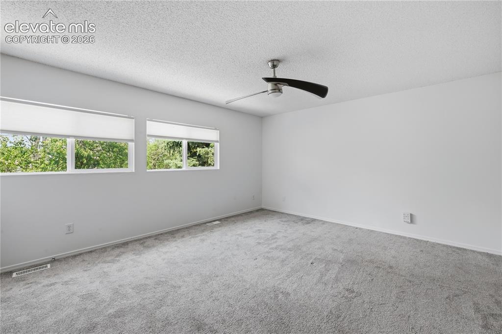 Image 11 of 15: Upper level Primary bedroom, attached to bathroom