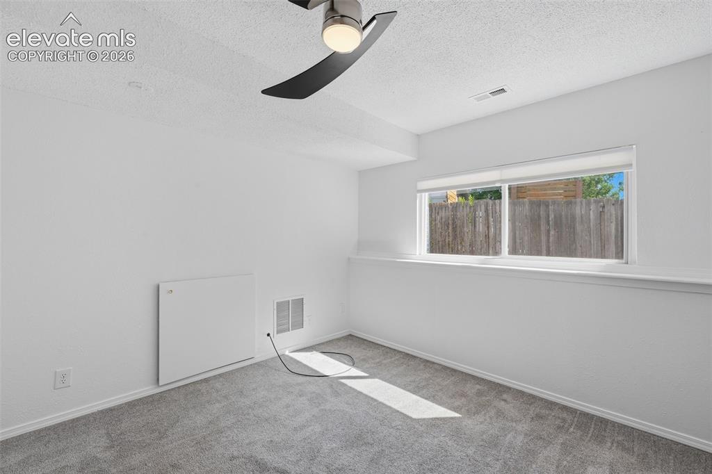 Image 14 of 29: Basement garden level bedroom to the left of the stairs.