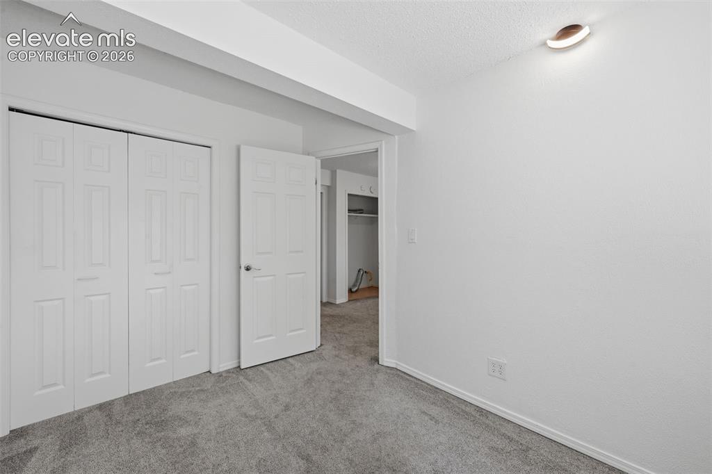 Image 18 of 29: Smaller basement bedroom to the right of the sitting area