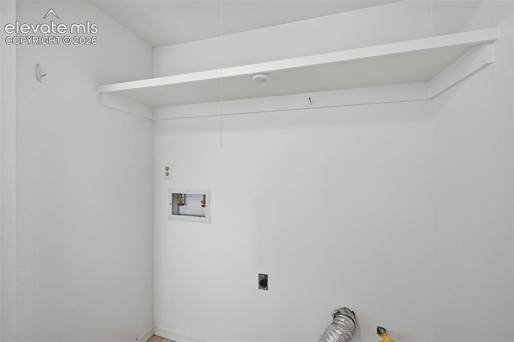 Image 19 of 29: Basement laundry closet plumbed for gas dryer or electric.