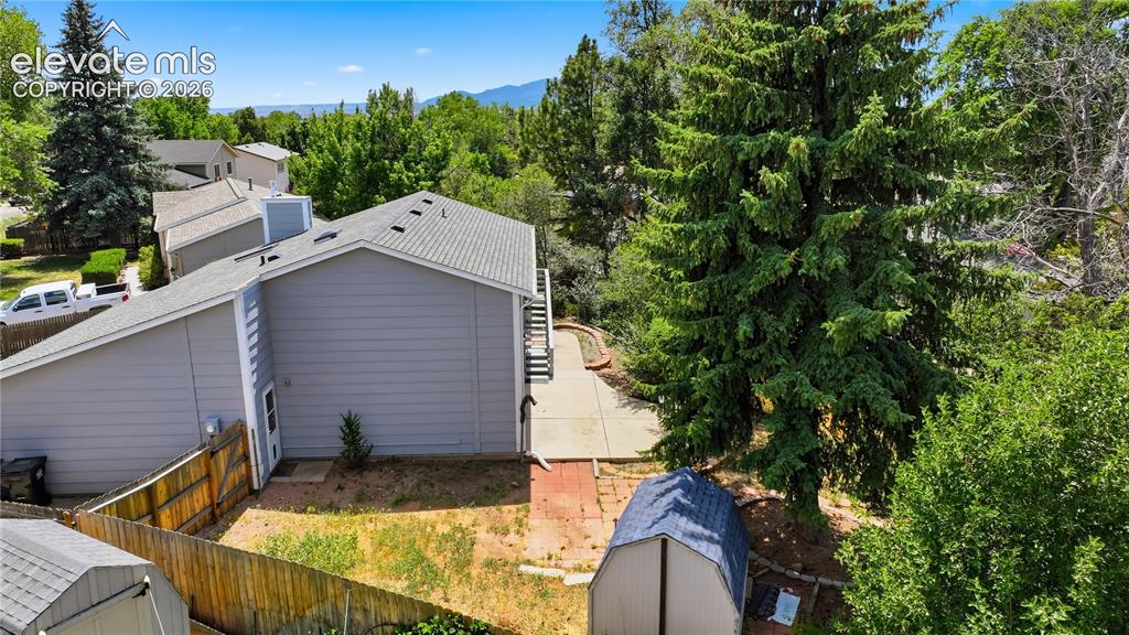 Image 23 of 29: Side yard showing door into garage and side gate and space for utility vehi