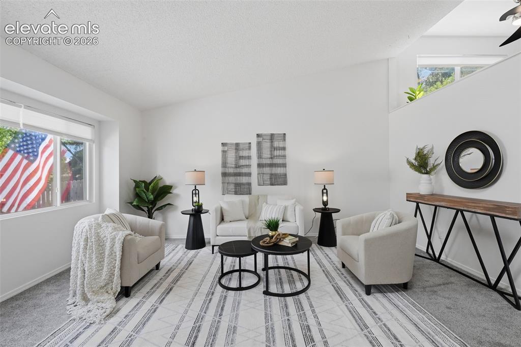 Image 3 of 29: Living room with vaulted ceilings open and airy