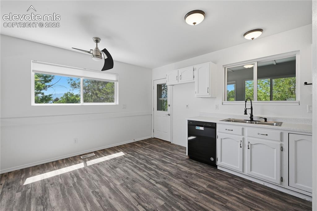 Image 5 of 15: Kitchen with eat in area, dor to enclosed patio area great for storage or p