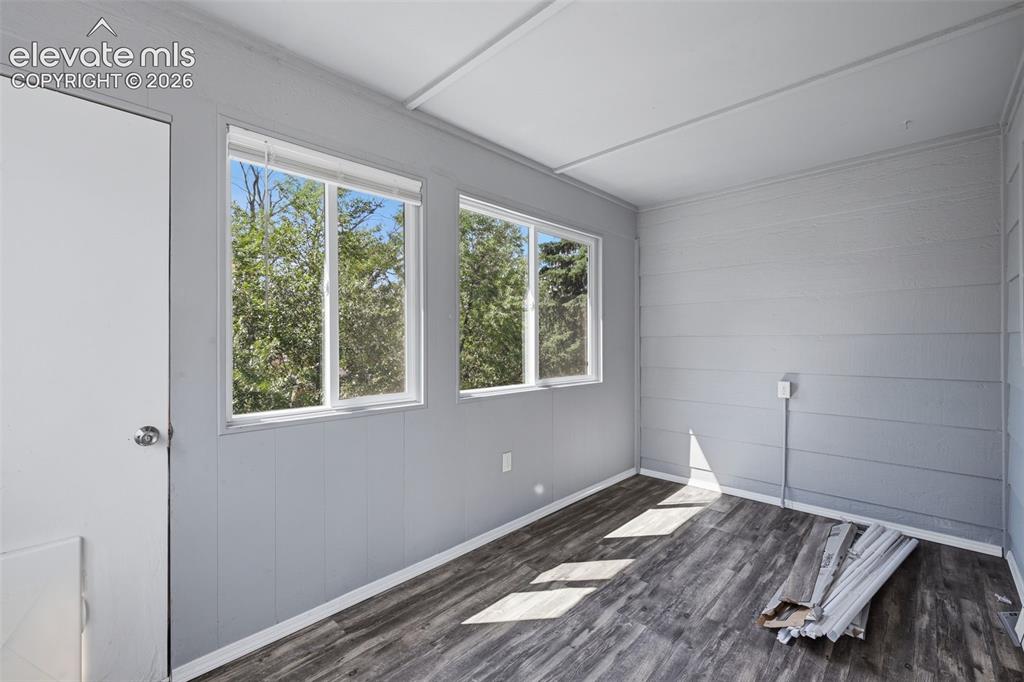 Image 9 of 29: Sunroom off of kitchen, could be used for storage, pets, summer eating or m