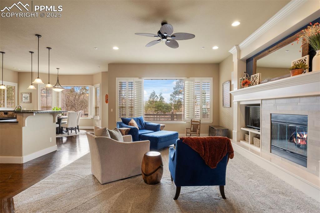 Image 14 of 50: Living area featuring a fireplace, a ceiling fan, recessed lighting, and da