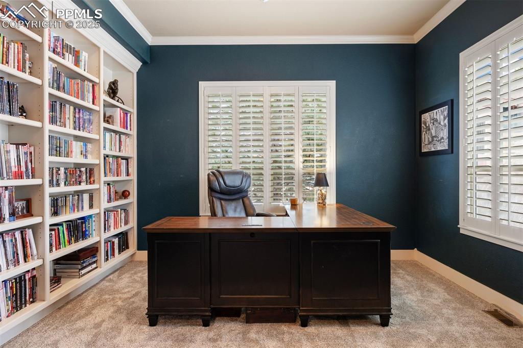 Image 15 of 50: Home office featuring light carpet and crown molding