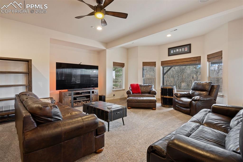 Image 33 of 50: Living area featuring carpet floors, recessed lighting, and a ceiling fan