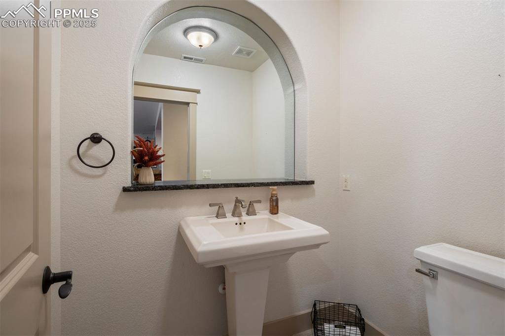 Image 37 of 50: Half bath featuring a textured wall