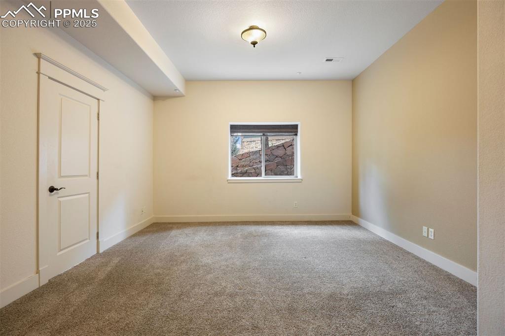 Image 41 of 50: Empty room featuring light colored carpet and baseboards