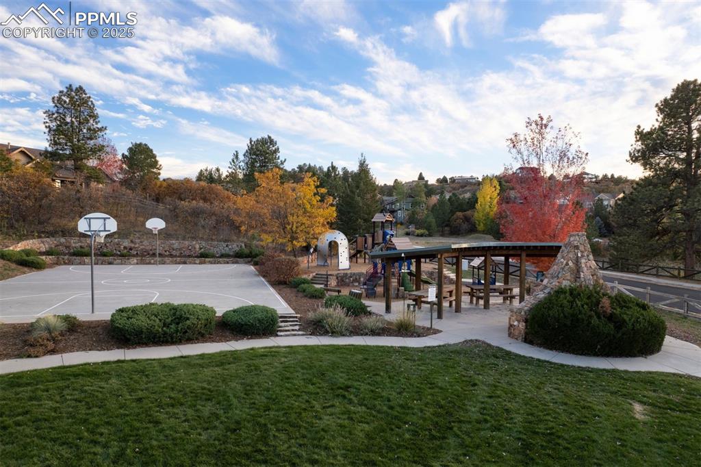 Image 47 of 50: View of community with a patio, a yard, community basketball court, and vie