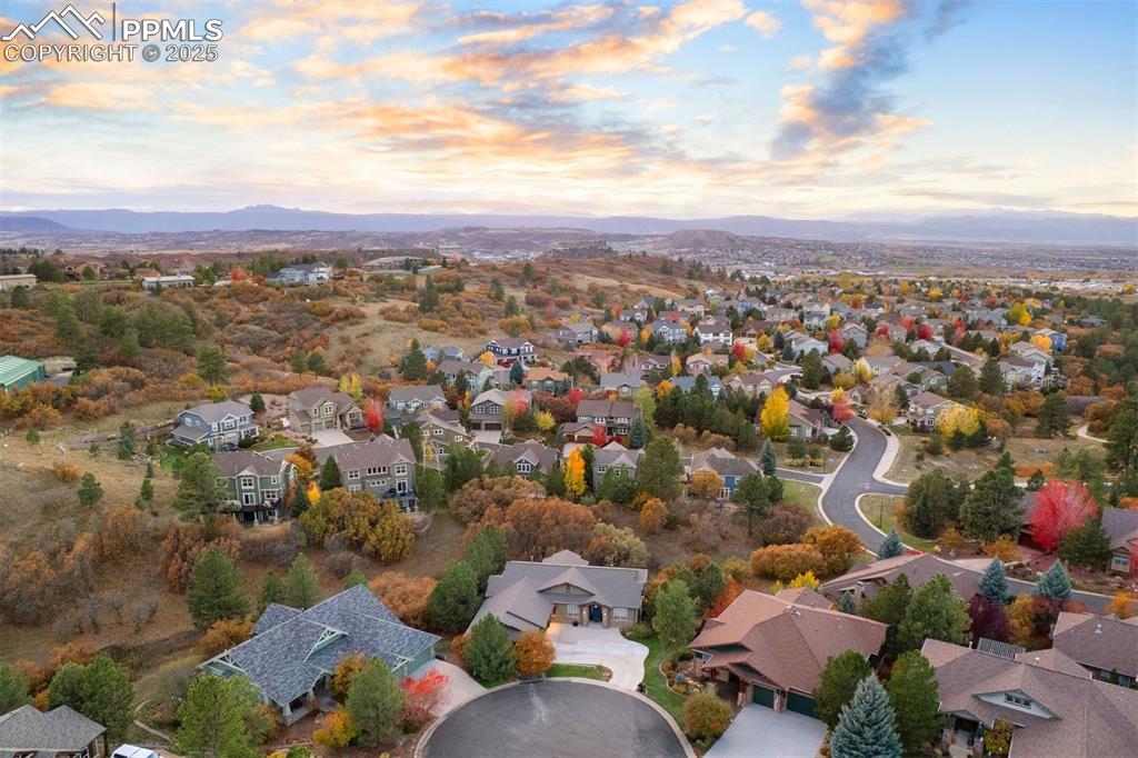 Image 48 of 50: Aerial perspective of suburban area with a mountain backdrop