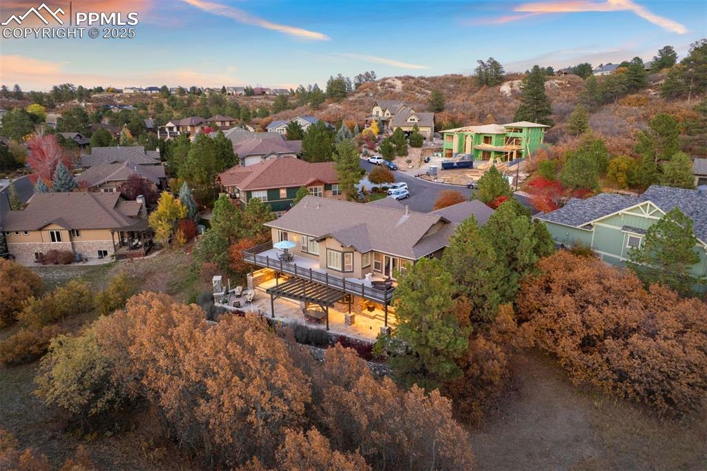 Image 49 of 50: Aerial view of residential area with a tree filled landscape