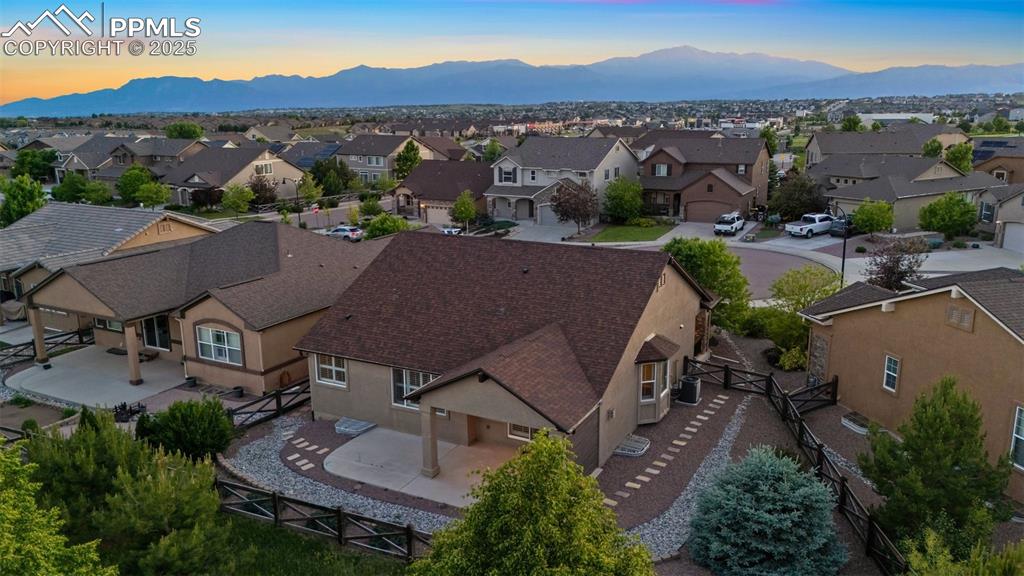 Image 10 of 50: Aerial view of residential area featuring a mountainous background