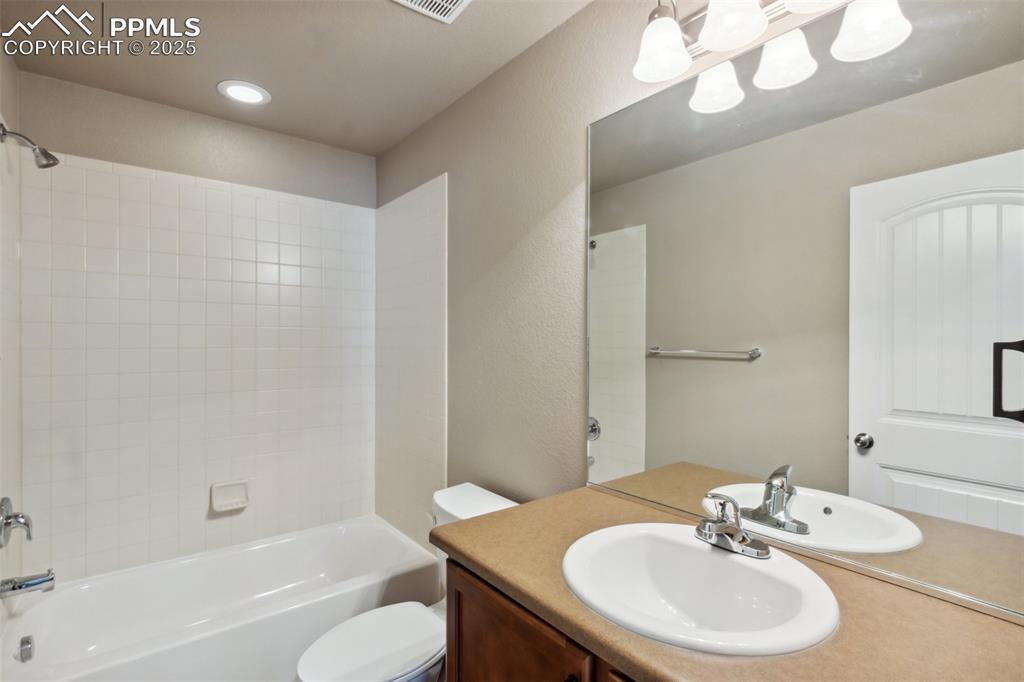 Image 20 of 50: Bathroom Upstairs with vanity, tub / shower combination, and recessed light