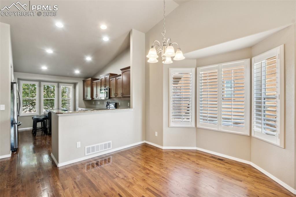 Image 23 of 50: Kitchen featuring dark wood-type flooring, appliances with stainless steel 