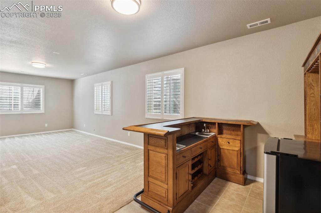 Image 30 of 50: Basement with wet bar