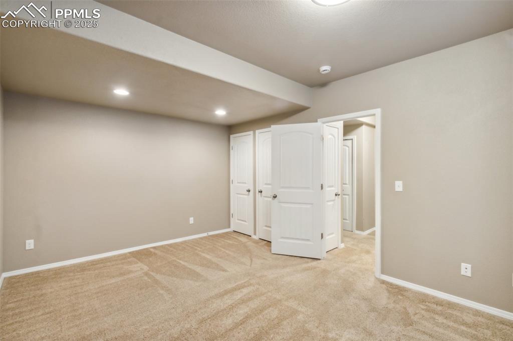 Image 35 of 50: Unfurnished bedroom featuring light colored carpet, baseboards, and recesse