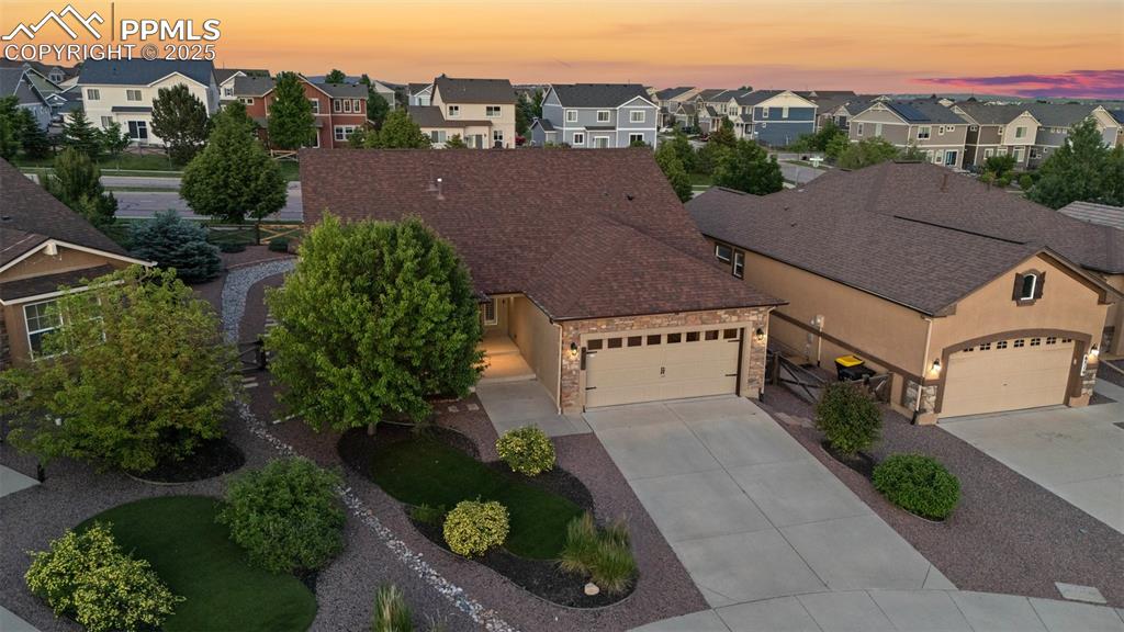 Image 39 of 50: View of front of house featuring a residential view, concrete driveway, a g