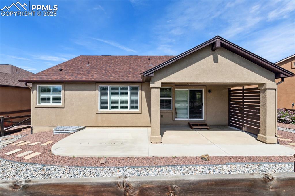 Image 43 of 50: Back of house featuring stucco siding, a patio area, and roof with shingles