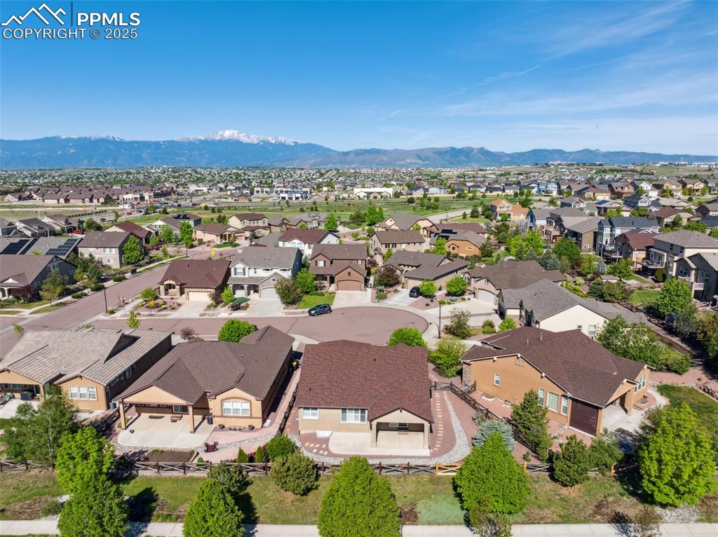 Image 46 of 50: Aerial perspective of suburban area with mountains