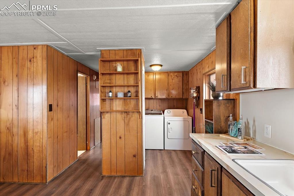Image 13 of 50: Kitchen featuring washing machine and clothes dryer, light countertops, bro