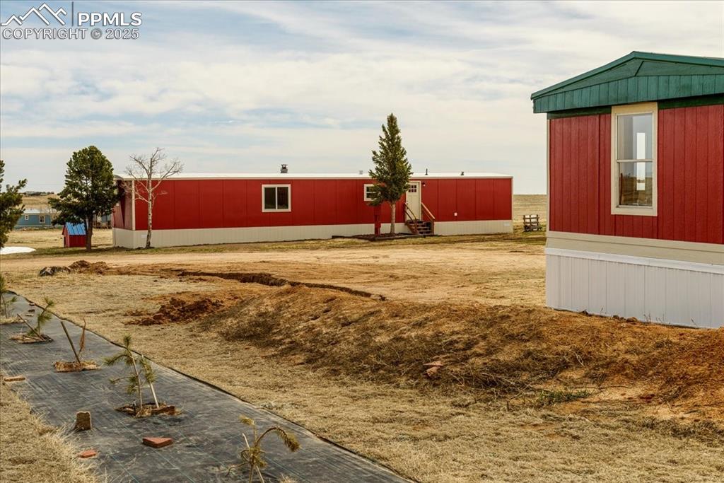 Image 23 of 50: View of yard featuring entry steps