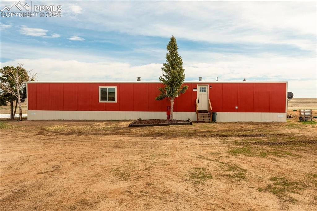 Image 26 of 50: View of front facade with an outbuilding and entry steps