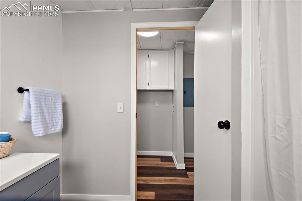 Image 36 of 50: Bathroom with baseboards, wood finished floors, and vanity