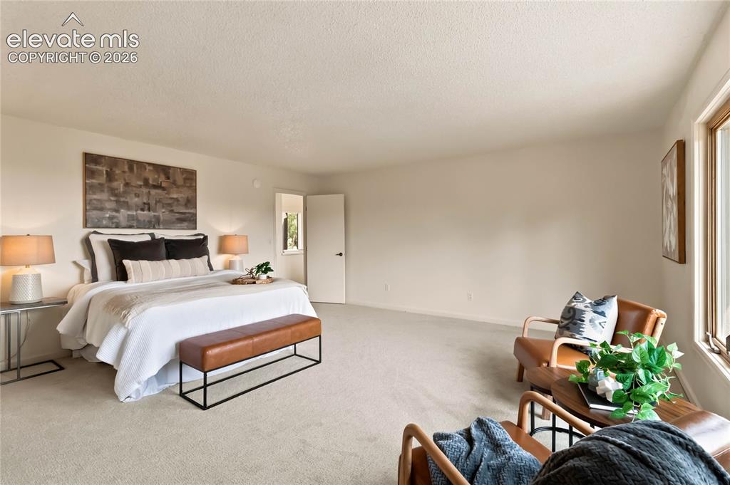 Image 21 of 49: Spacious room with light-toned carpeting and neutral wall tones