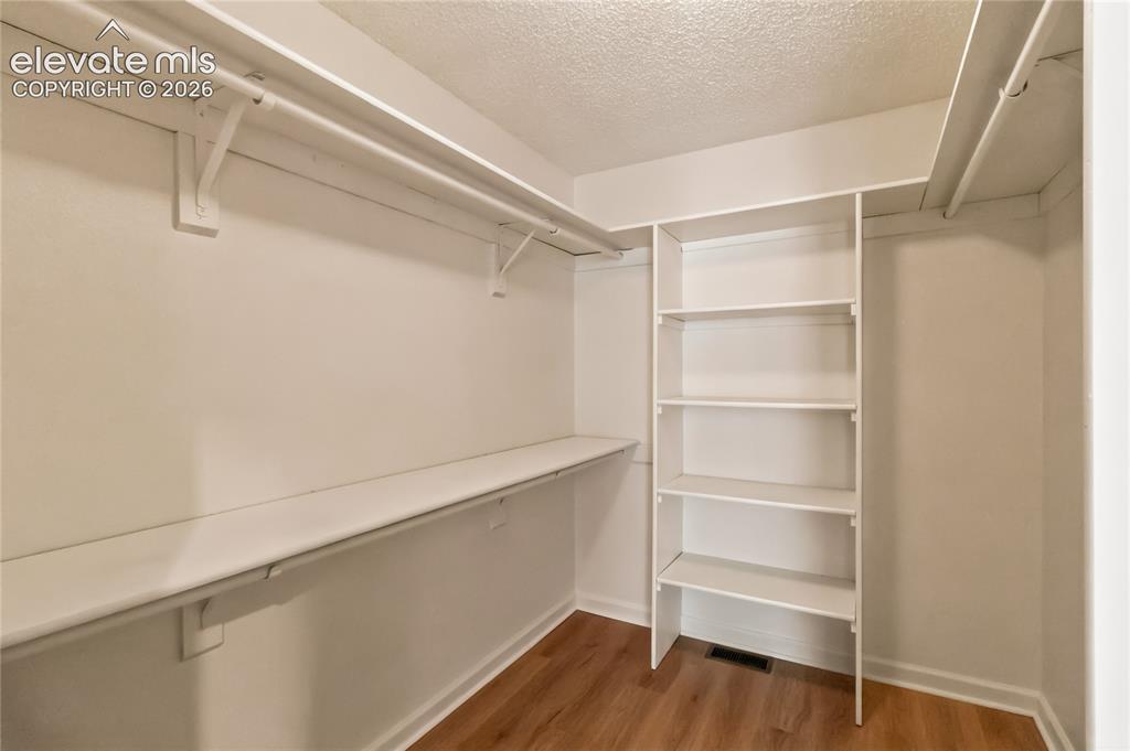 Image 25 of 49: Built-in shelving and hanging rods